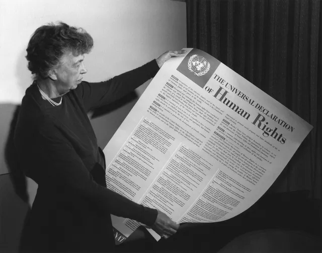 Eleanor Roosevelt holding a poster of the Universal Declaration of Human Rights